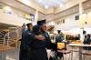 Graduate hugs their family member after receiving their degree.