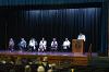 Faculty from the Anesthesiologist Assistant and Physician Assistant programs and Shonna Riedlinger, Acting President, listen as Aaron Grabovich, Program Director of Anesthesiologist Assistant Program, addresses the graduates.